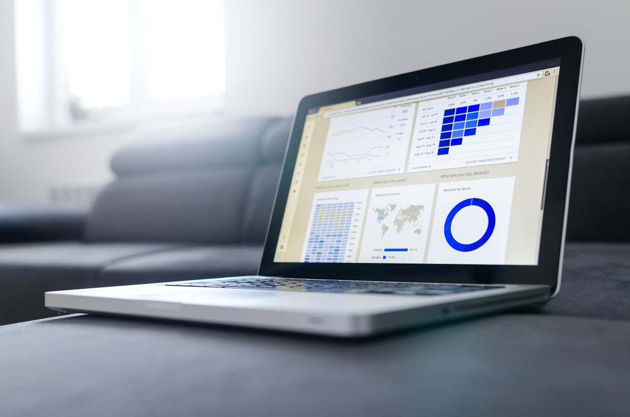 hero-img Sleek laptop showcasing data analytics and graphs on the screen in a bright room.